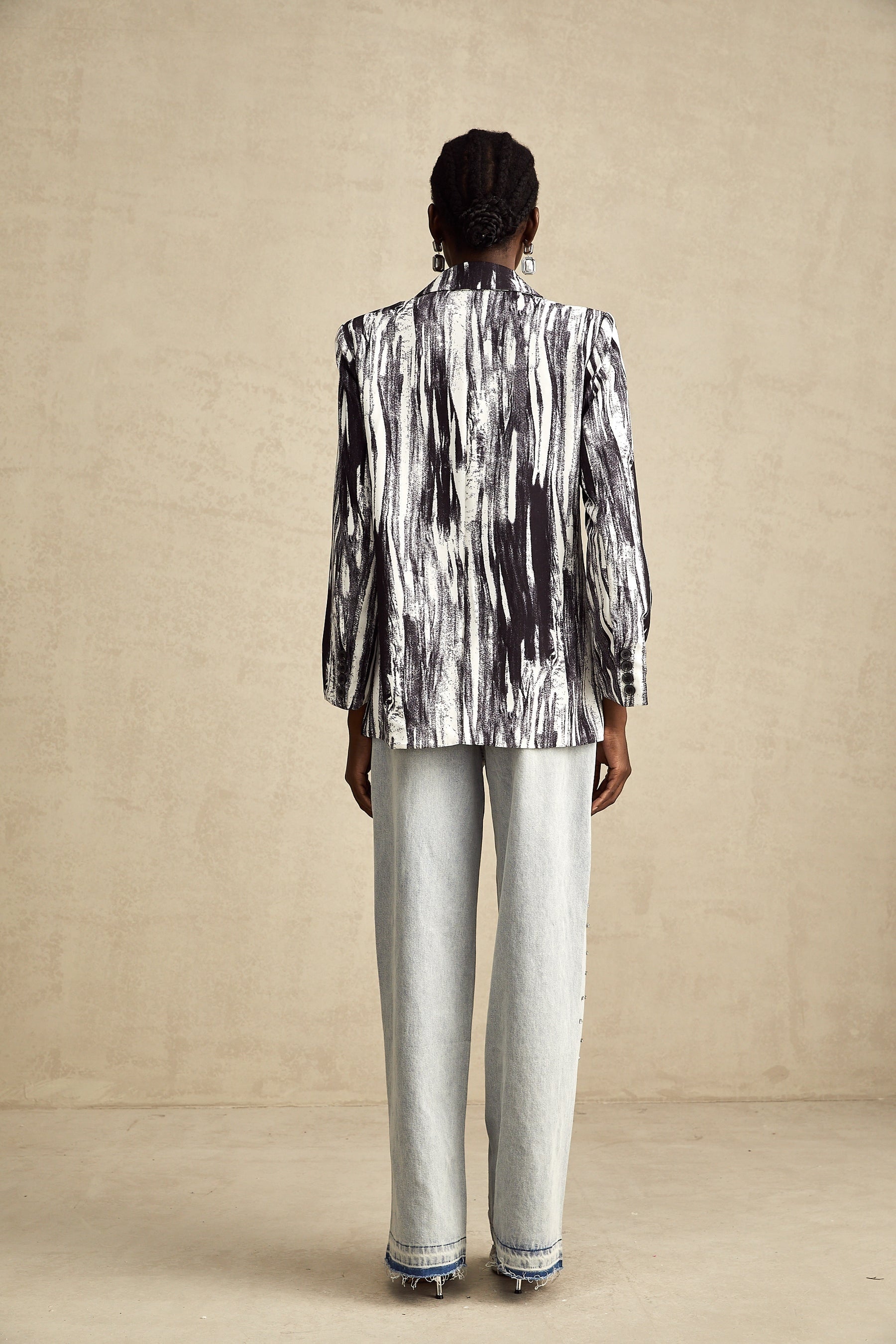 Black jacket with graffiti print design and textured fabric named Elise