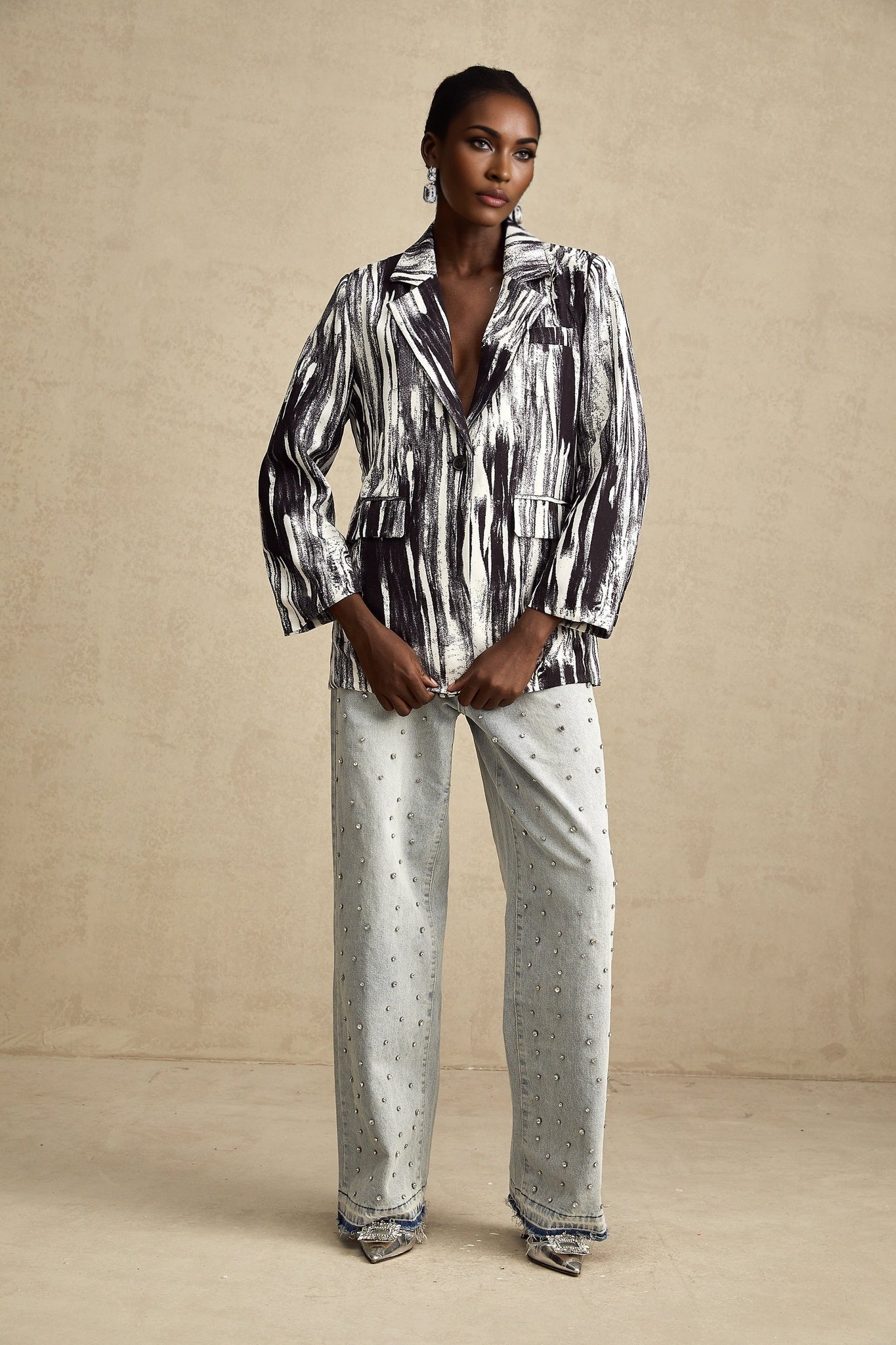 Black jacket with graffiti print design and textured fabric named Elise