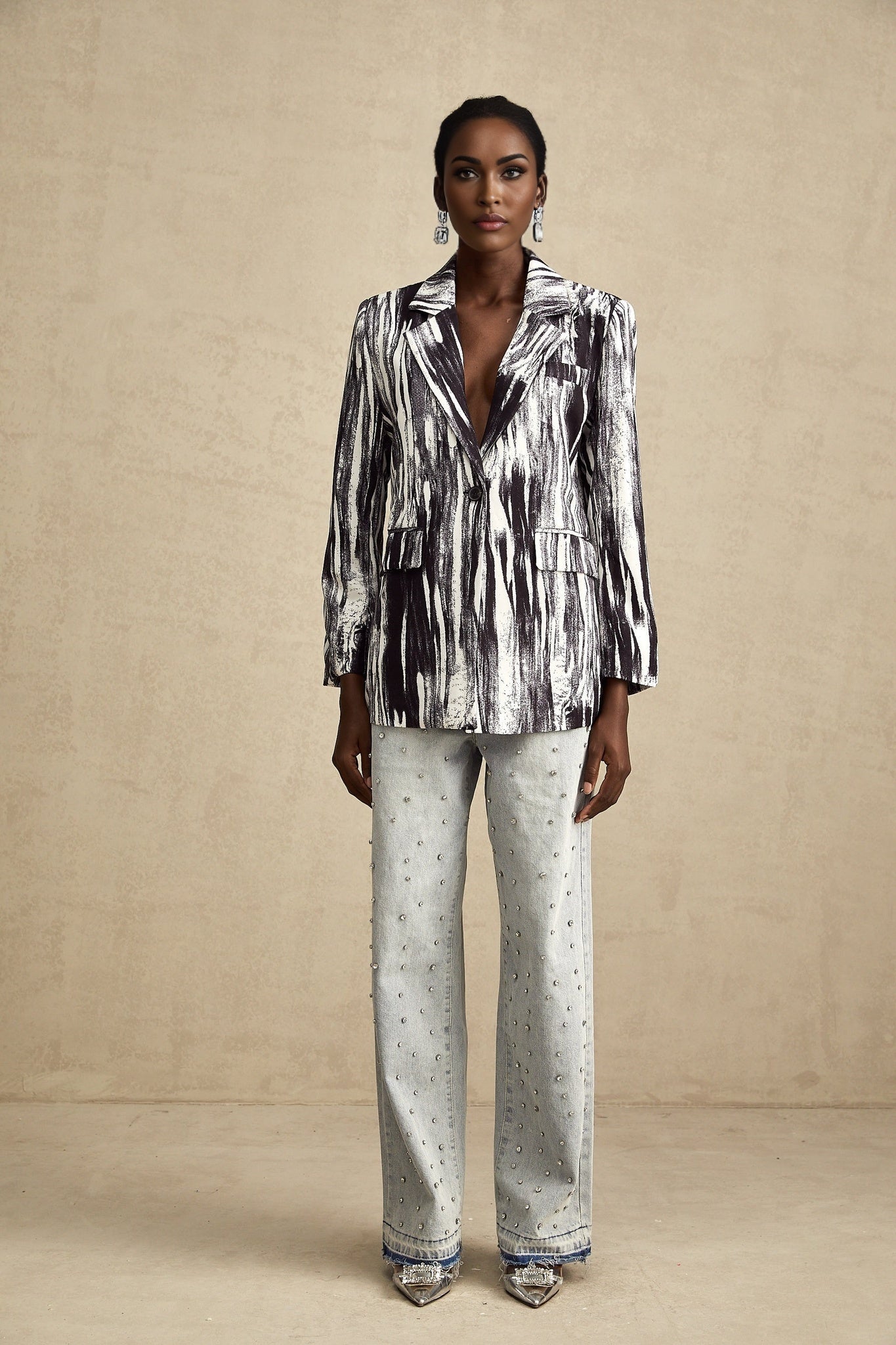 Black jacket with graffiti print design and textured fabric named Elise