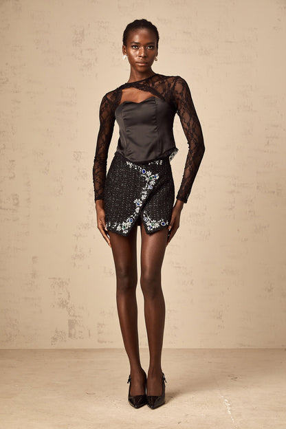 Black lace top with cutout design and short sleeves suitable for casual or evening wear
