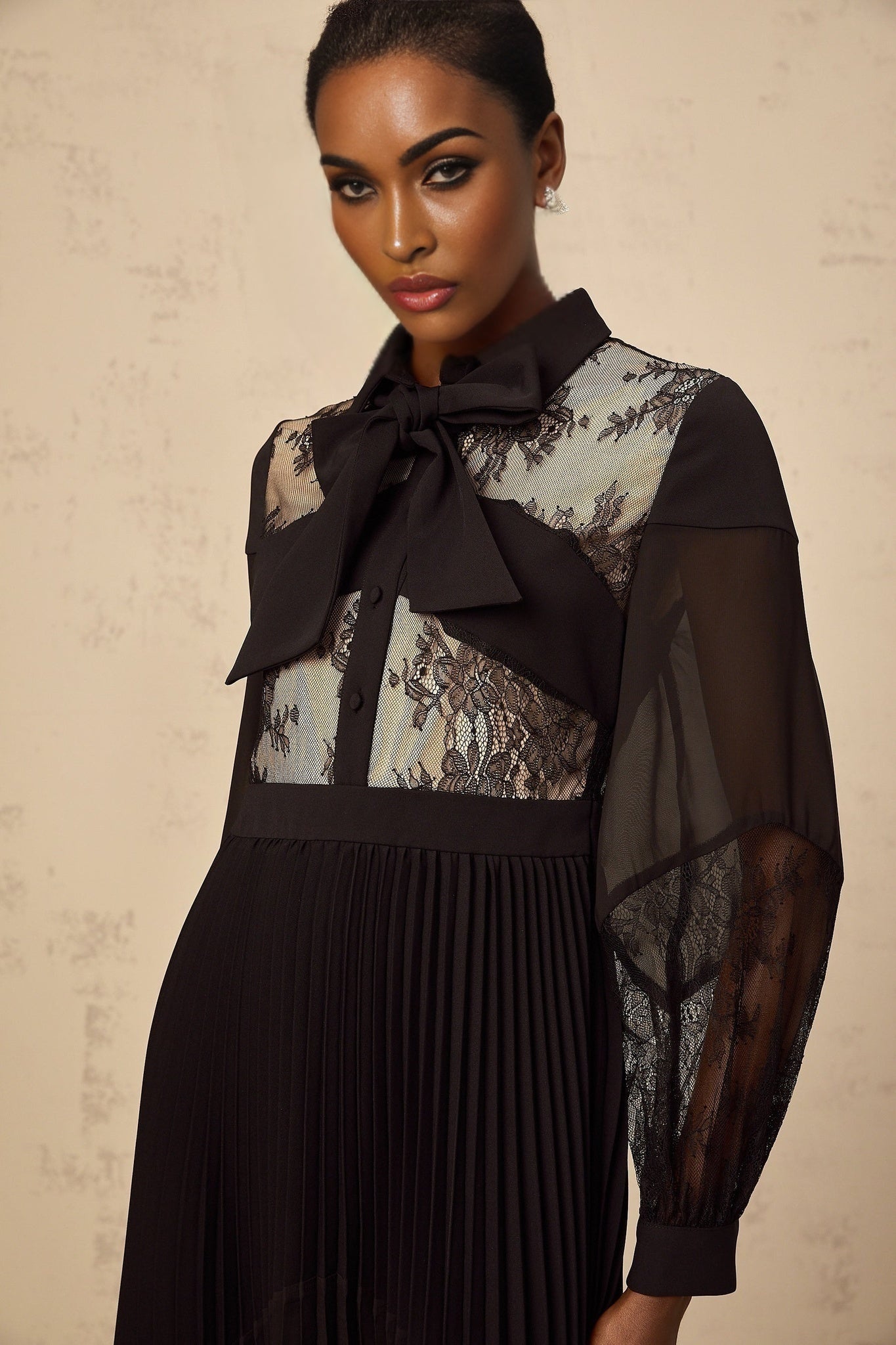 Black maxi dress with floral lace panels and pleated design named Segolene
