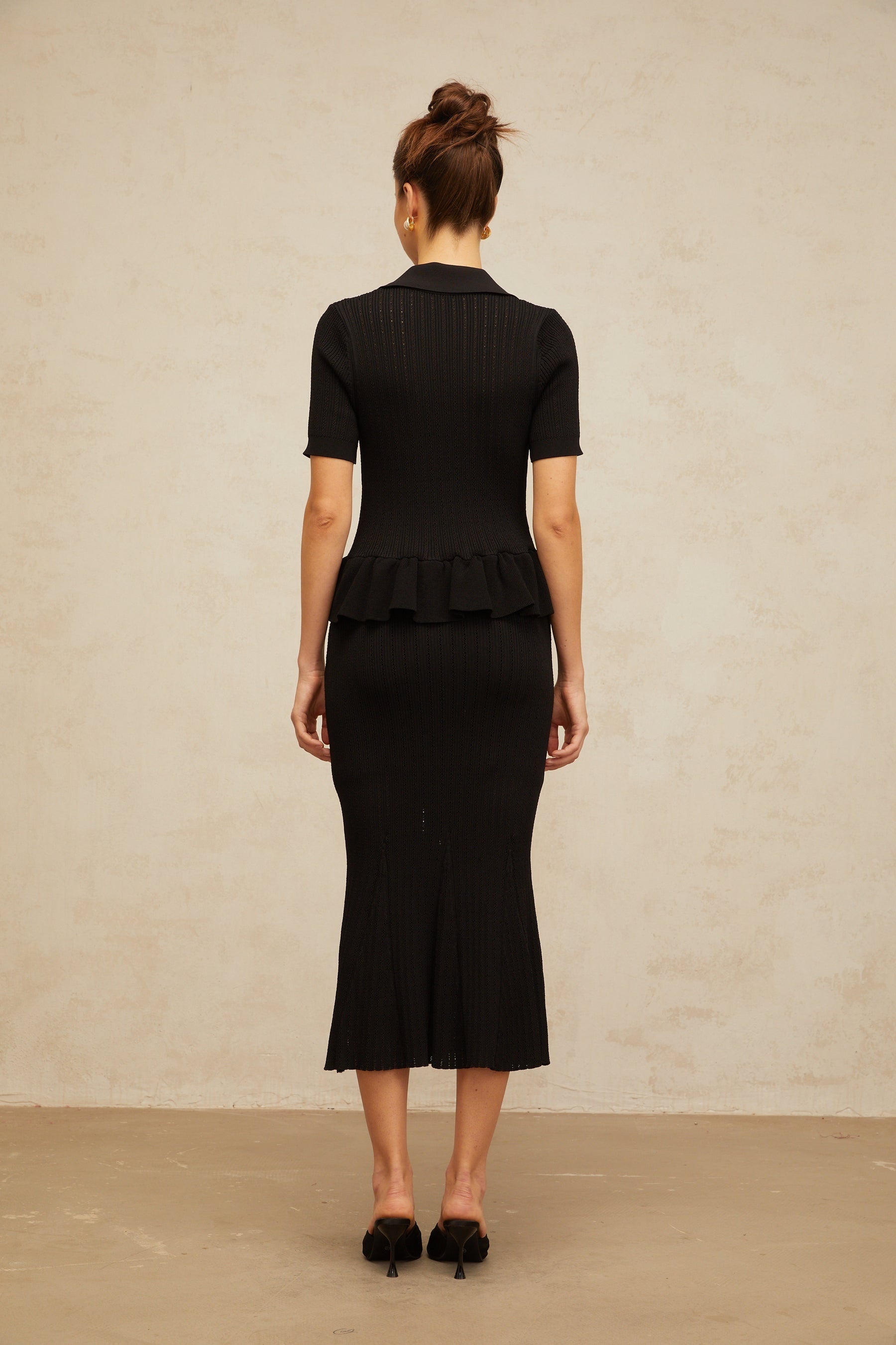 Black midi dress with embellished pointelle knit pattern and intricate detailing