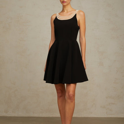 Black mini dress with faux pearl embellishments called Danae