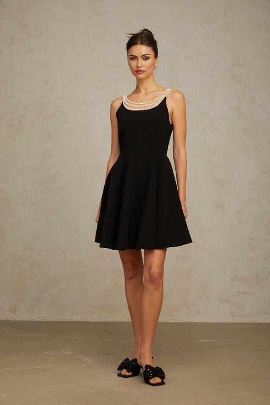 Black mini dress with faux pearl embellishments called Danae