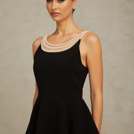 Black mini dress with faux pearl embellishments called Danae