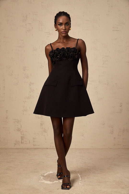 Black mini dress with flared skirt and rose applique details