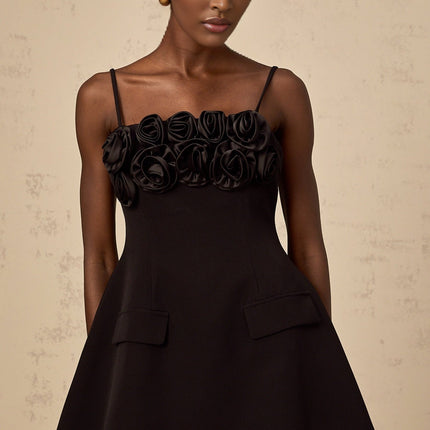 Black mini dress with flared skirt and rose applique details