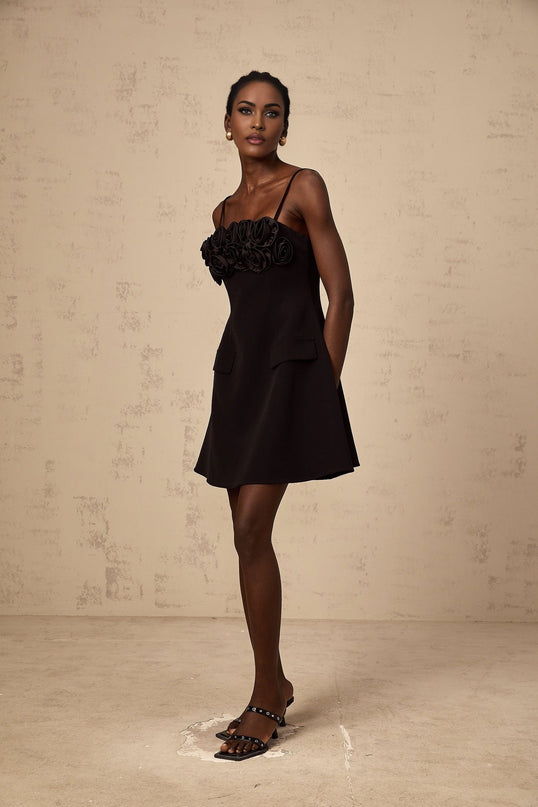 Black mini dress with flared skirt featuring rose applique details and Mignon design