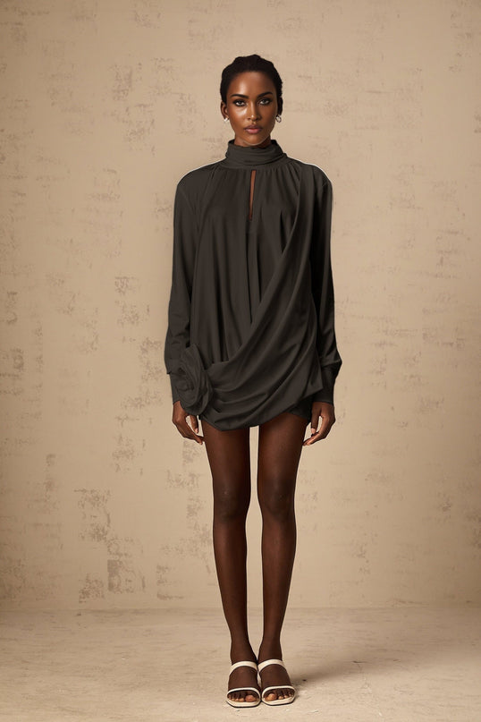 Black mini dress with ruched fabric and faux flower detailing called Maeva