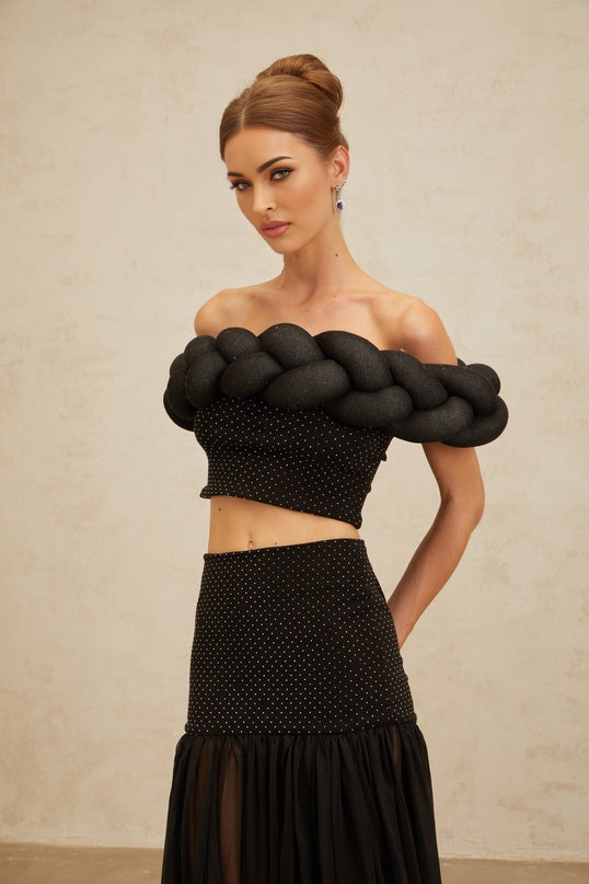 Black off the shoulder cropped top with braid detailing and rhinestone embellishment