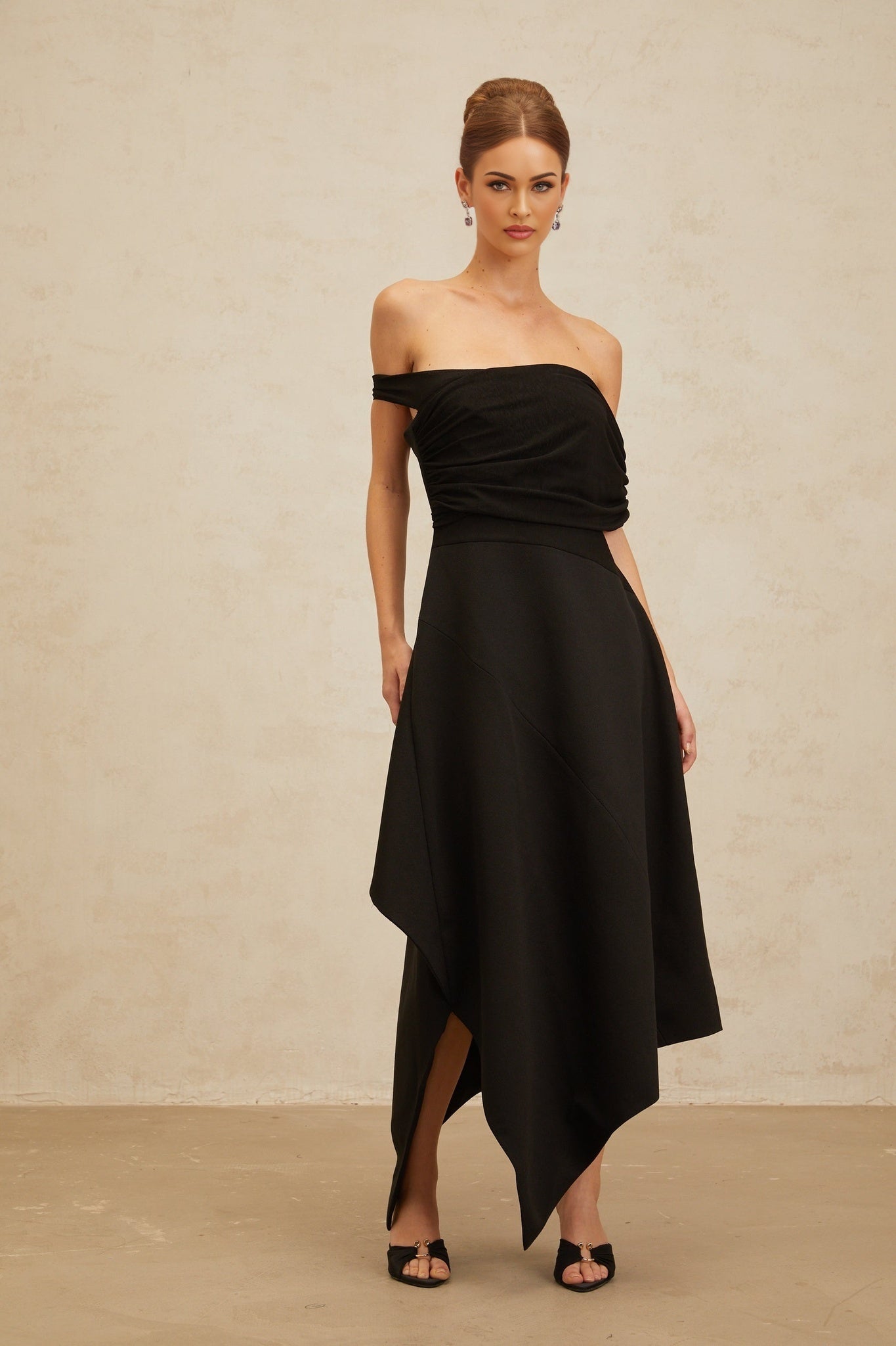 Black off the shoulder maxi dress with cinched waist and asymmetrical design