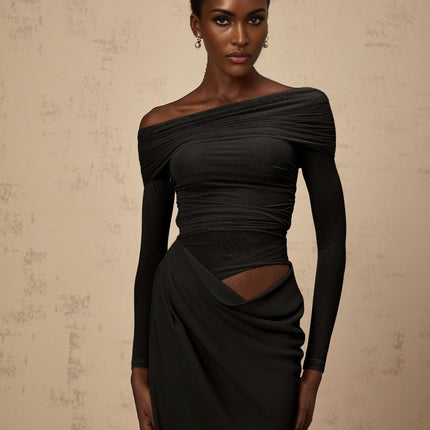 Black off shoulder midi dress with semi sheer fabric on a plain background