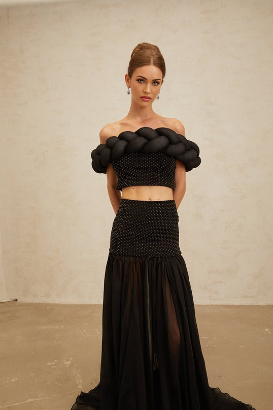 Black off the shoulder cropped top with braid detailing and rhinestone embellishment