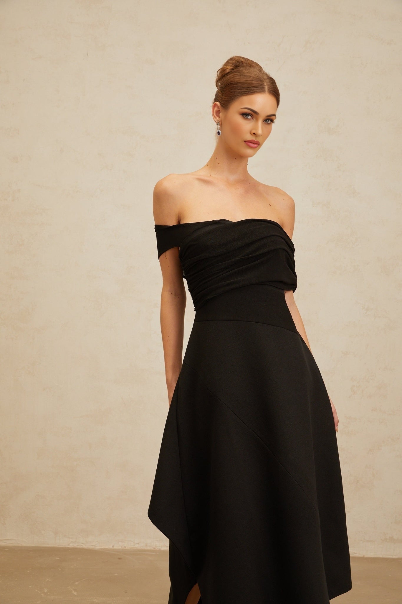 Black off the shoulder maxi dress with cinched waist and ruched detailing