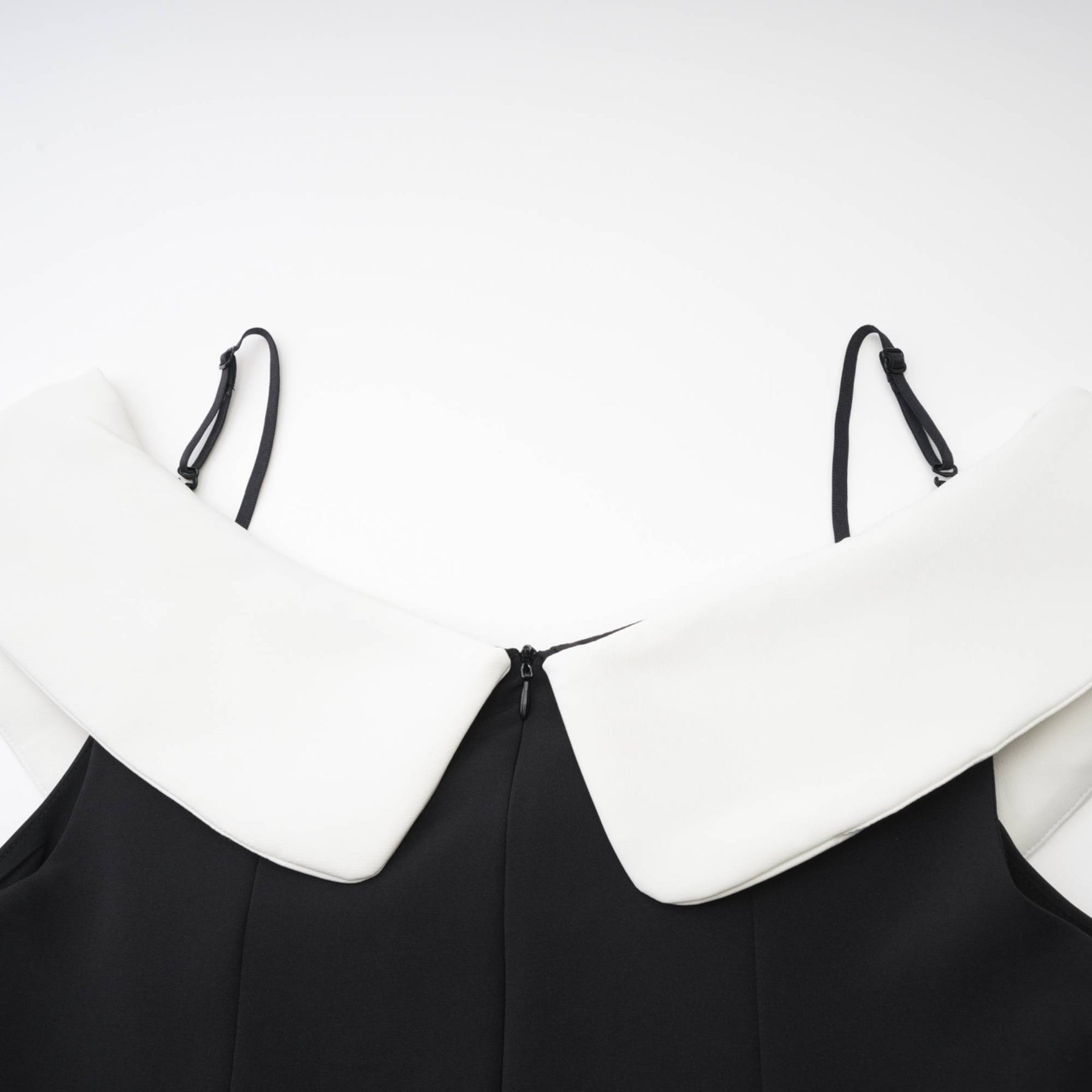 Black mini dress with reversable collar off the shoulder design contrast colors spaghetti straps pleated style front bowknot detailing and composed of 82% Cotton 18% Silk