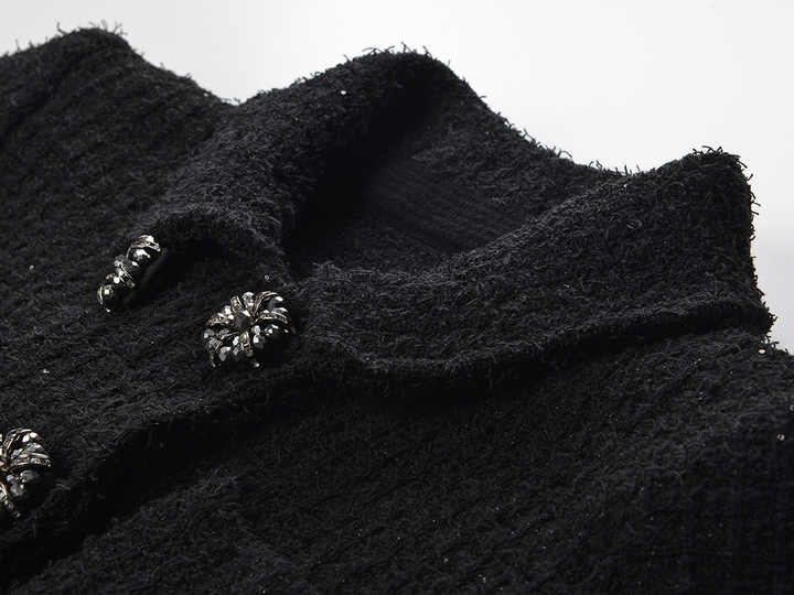 Black peplum silhouette jacket and skirt ensemble with sparkle textured fabric