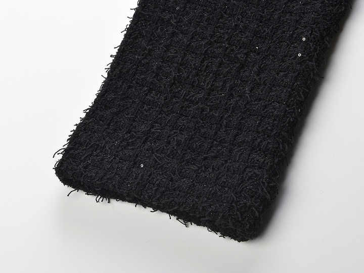 Black peplum silhouette jacket and skirt ensemble with sparkle textured fabric and decorative buttons on pockets