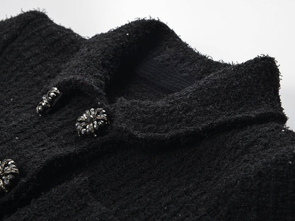 Black peplum silhouette jacket and skirt ensemble with decorative buttons on pockets