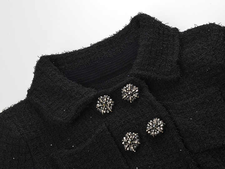 Black peplum top and fitted skirt ensemble with decorative buttons and pockets