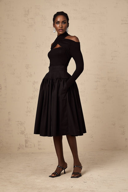 Black pleated midi skirt with flared silhouette named Pauline