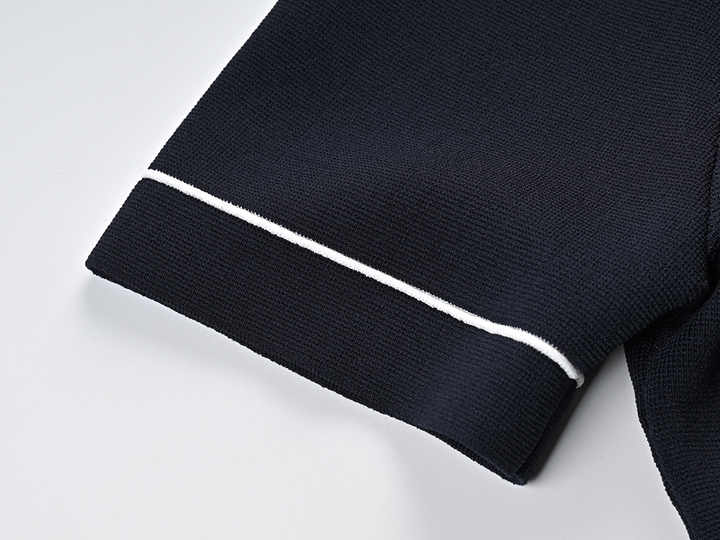 Black polo top with pleated skirt and white accents