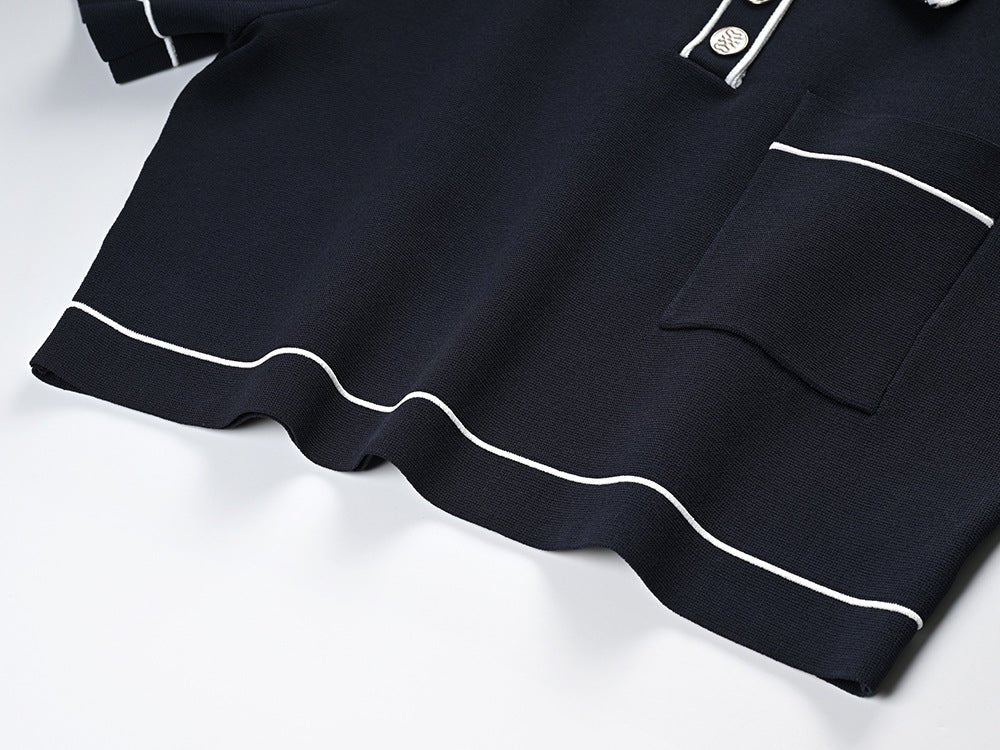 Black polo top with pleated skirt and white accents