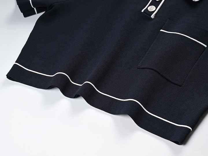 Black polo top with pleated skirt and white accents