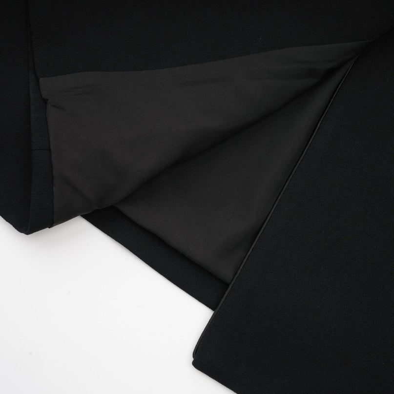 Black single breasted long coat by Aelle