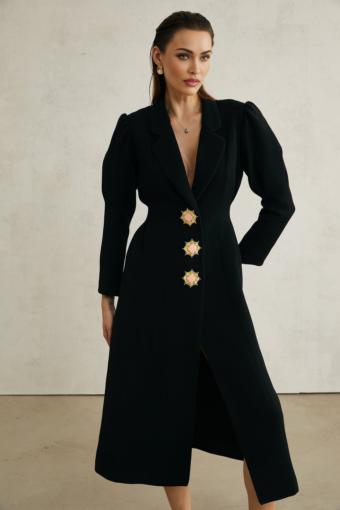 Black single breasted long coat by Aelle