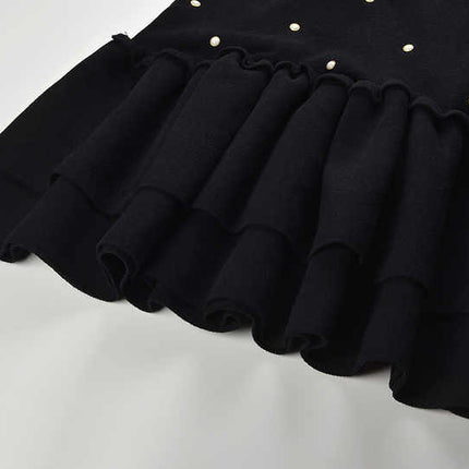 Black sleeveless dress with pearl embellishments and ruffle hem