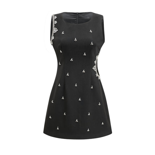 Black dress with accentuating contrast colors sleeveless design classy round neck unique cutout design sparkling crystal embellishments rear zip fastening stylish thigh length made of 100% Polyester
