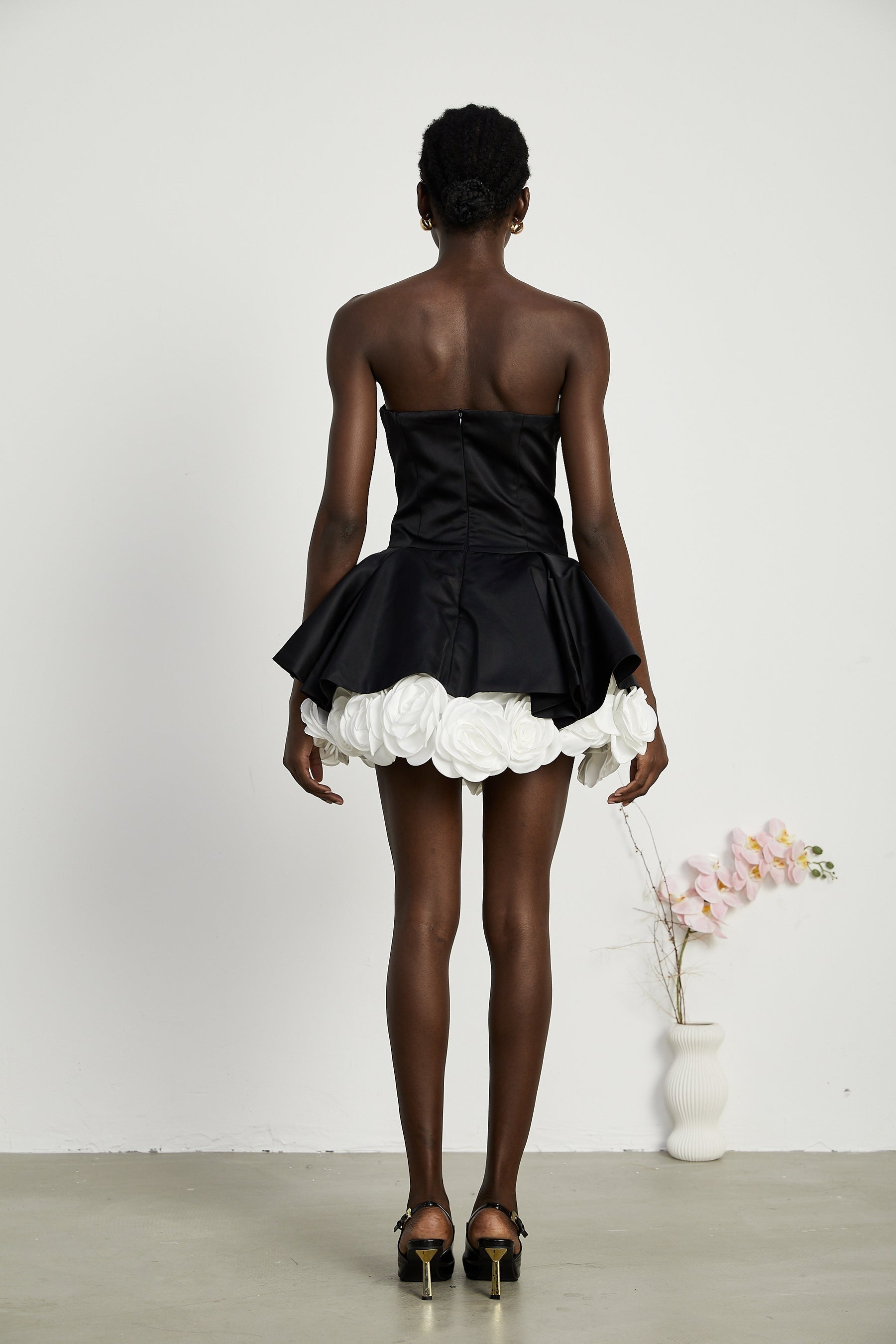 Black strapless corset mini dress with petal details called Lucie
