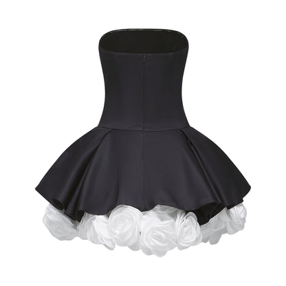 Black strapless mini dress with corset style bodice and floral petal details named Lucie