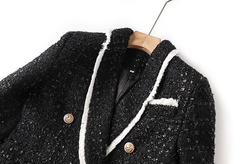 Black tailored blazer with shorts double-breasted belted waist structured fitted silhouette tweed fabric gold-tone buttons white accents chic sophisticated look modern twist on classic styles