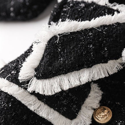 Black tailored blazer with shorts double-breasted belted waist structured fitted silhouette chic sophisticated look spring fall tweed fabric texture gold-tone buttons trim semi-formal events modern twist classic styles