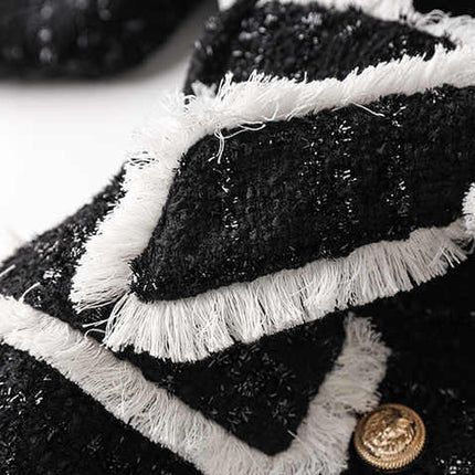 Black tailored blazer with shorts double-breasted belted waist structured fitted silhouette chic sophisticated look tweed fabric gold-tone buttons trim semi-formal events modern twist classic styles