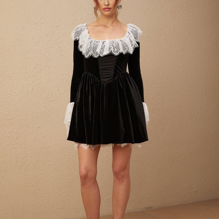 Black velvet mini dress with lace trim detailing named Fabiana