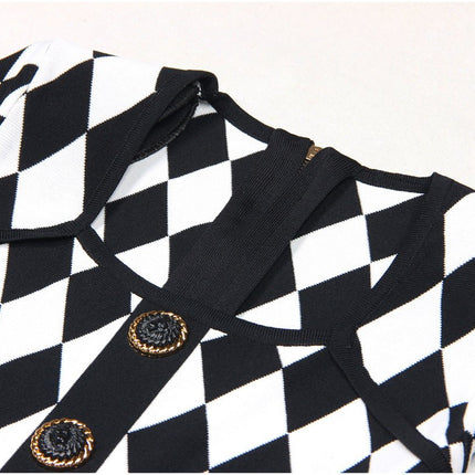 Black and white geometric harlequin pattern dress with gold decorative buttons