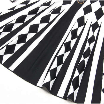 Black and white geometric harlequin pattern fitted dress with gold buttons