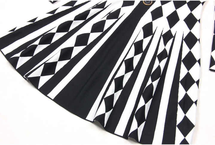 Black and white geometric harlequin pattern fitted dress with gold buttons