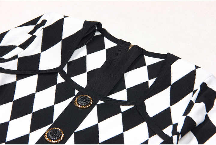 Black and white geometric harlequin pattern fitted dress with gold decorative buttons