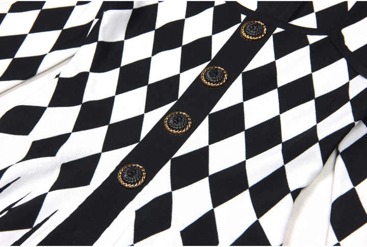 Black and white geometric harlequin pattern fitted dress with gold decorative buttons