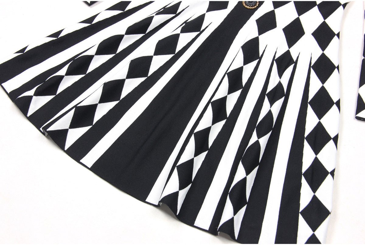 Black and white geometric harlequin pattern fitted dress with gold decorative buttons