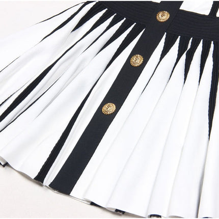 Black and white halter neck dress with gold accents and rose embellishment