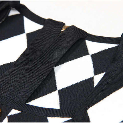Black and white harlequin pattern fitted dress with gold buttons