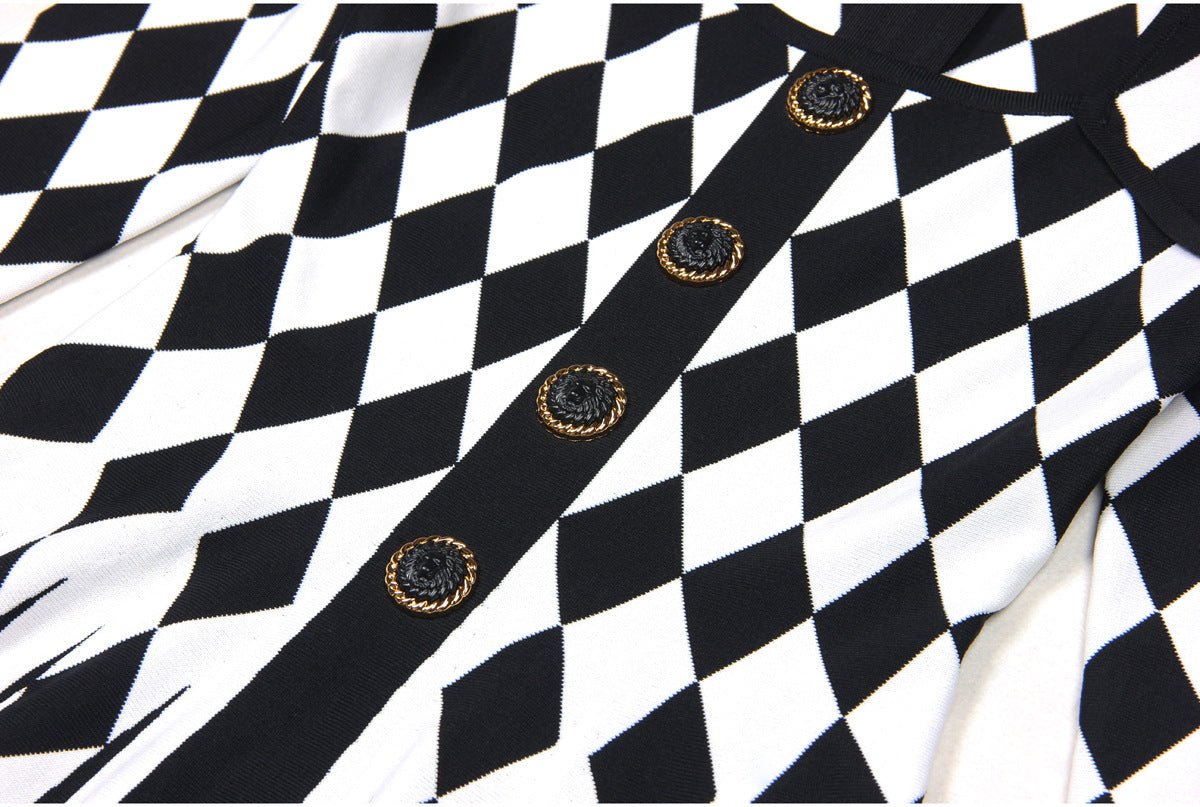Black and white harlequin pattern fitted dress with gold decorative buttons