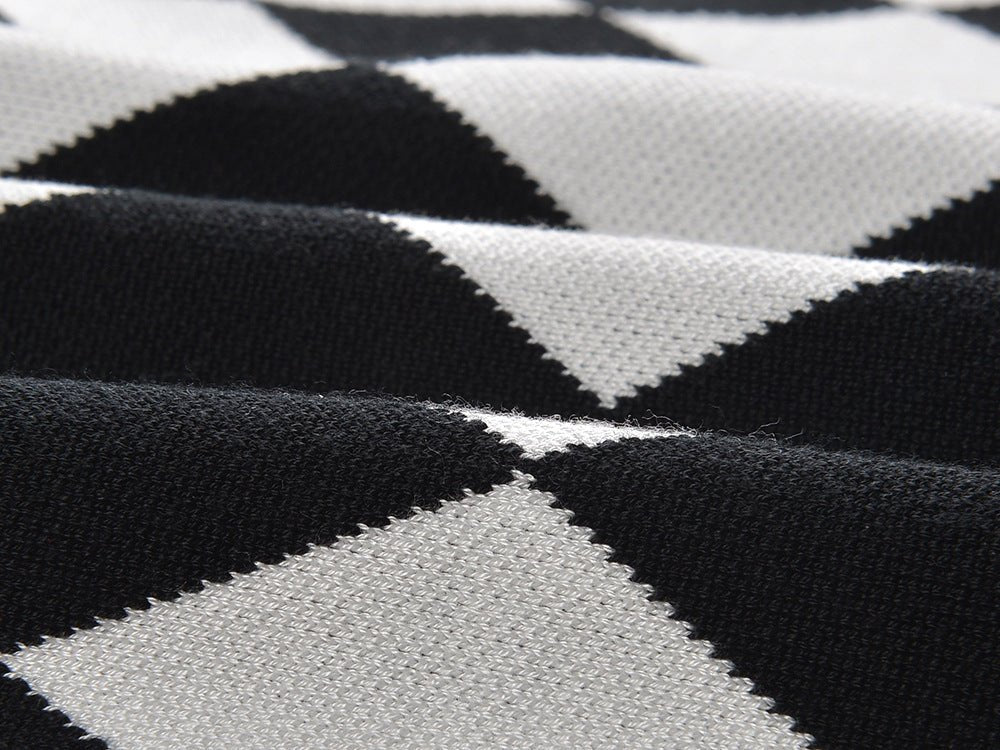 Black and white harlequin pattern pencil skirt with gold-button accents