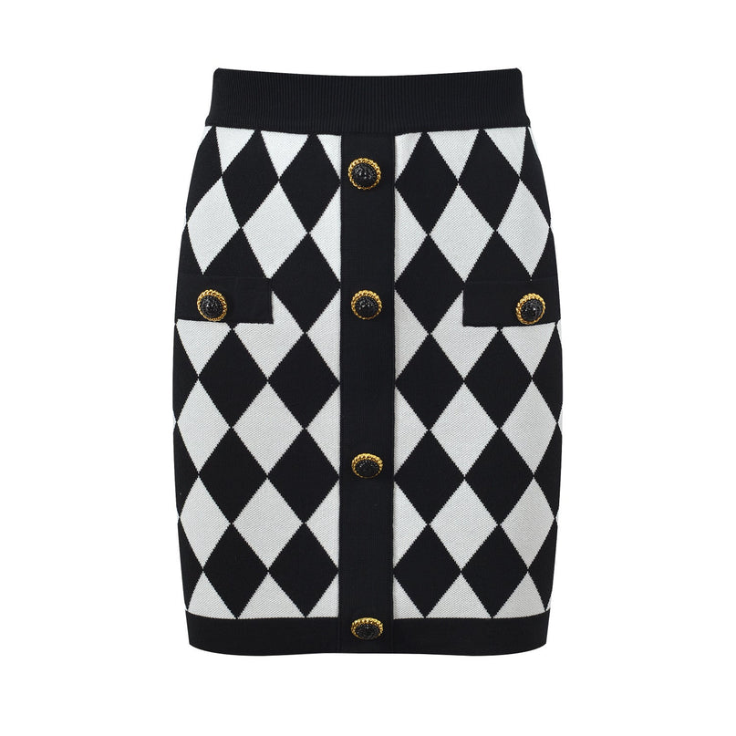 Form-fitting black and white harlequin pattern pencil skirt with gold-button accents on pockets