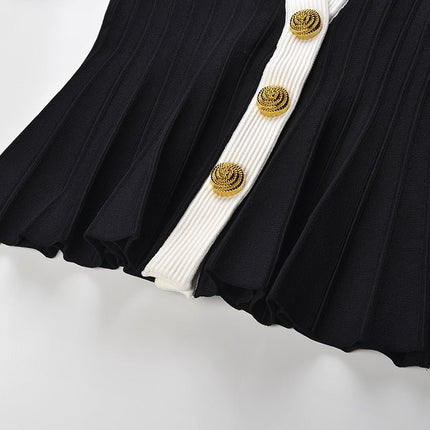 Black and white peplum style top with vertical ribbed texture and gold button embellishments