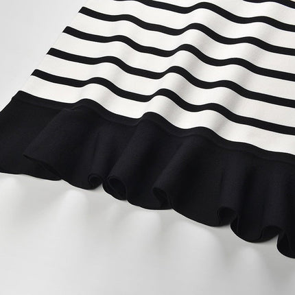 Black and white striped sleeveless body-con knit top with gold button accents on shoulders